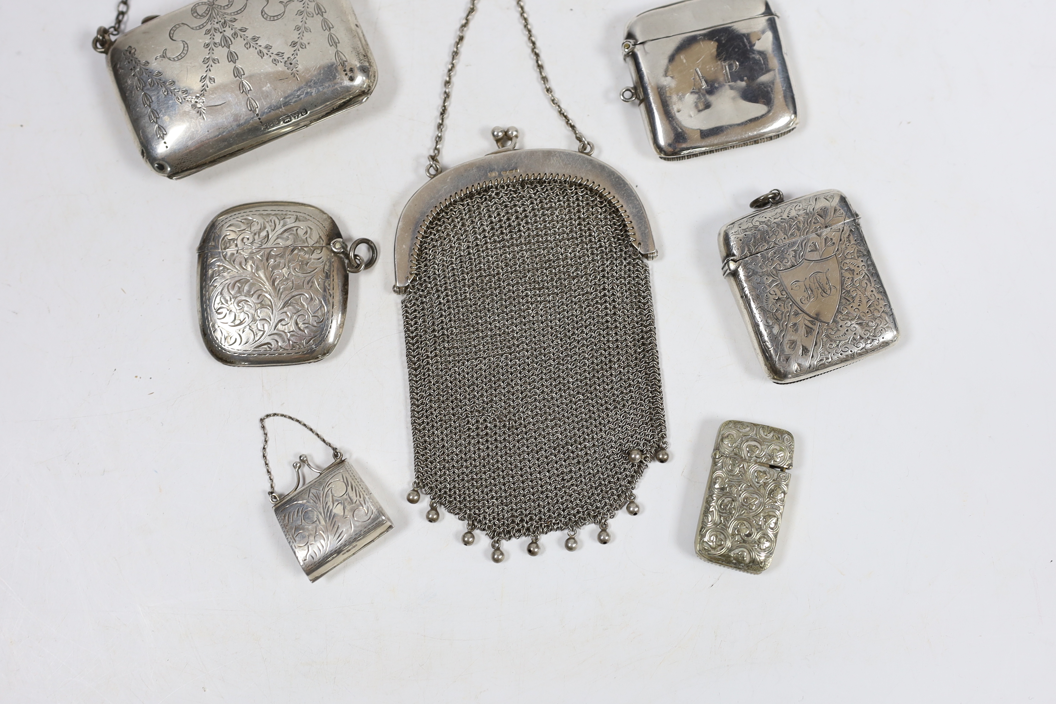 Four assorted early 20th century silver vesta cases and one base metal vesta case, two silver purses including mesh link and a small modern silver 'handbag' pill box.